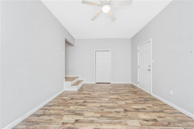 spare room with light wood-type flooring and ceiling fan