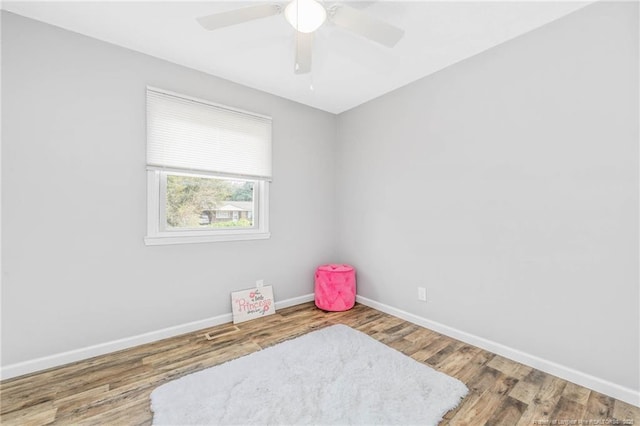 empty room featuring ceiling fan and hardwood / wood-style flooring