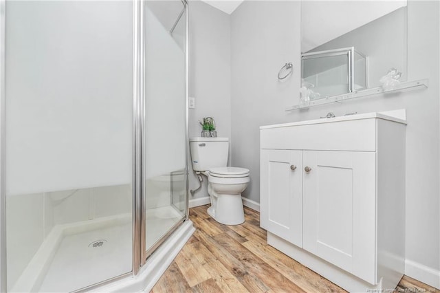 bathroom featuring vanity, hardwood / wood-style flooring, toilet, and an enclosed shower