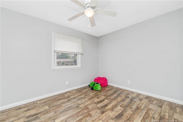 empty room featuring hardwood / wood-style flooring and ceiling fan