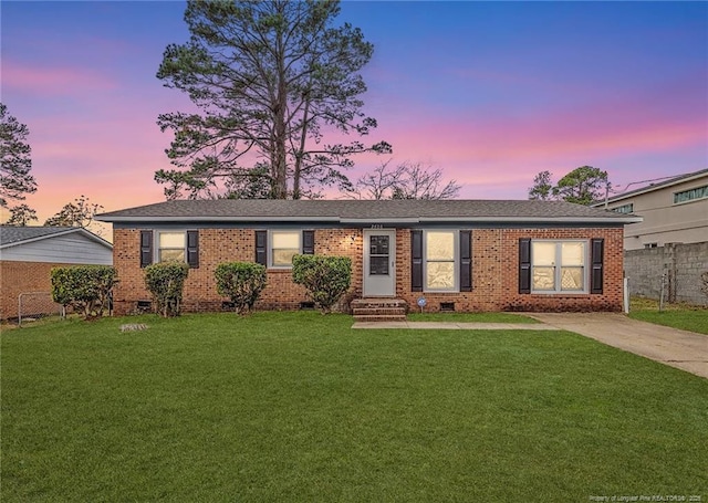 ranch-style home featuring a yard