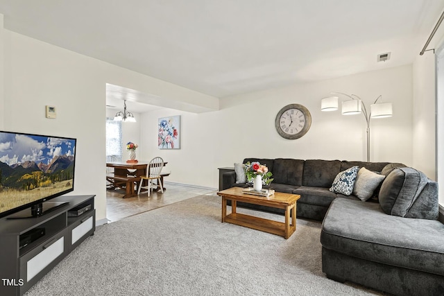 living room featuring an inviting chandelier and carpet flooring