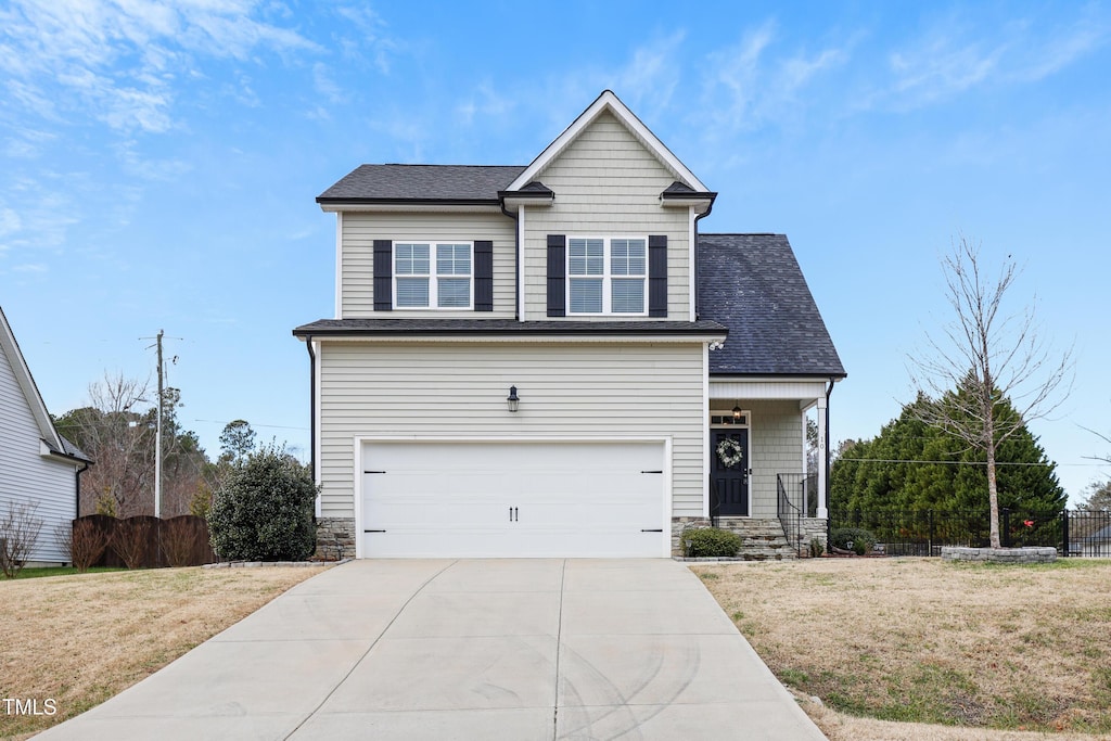 view of front of home with a garage and a front lawn