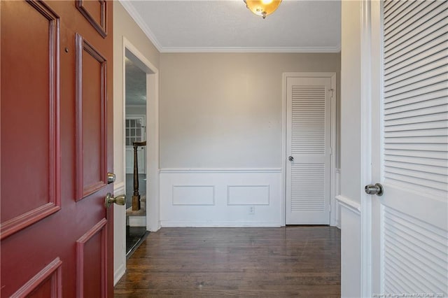 foyer entrance featuring crown molding and dark wood-type flooring