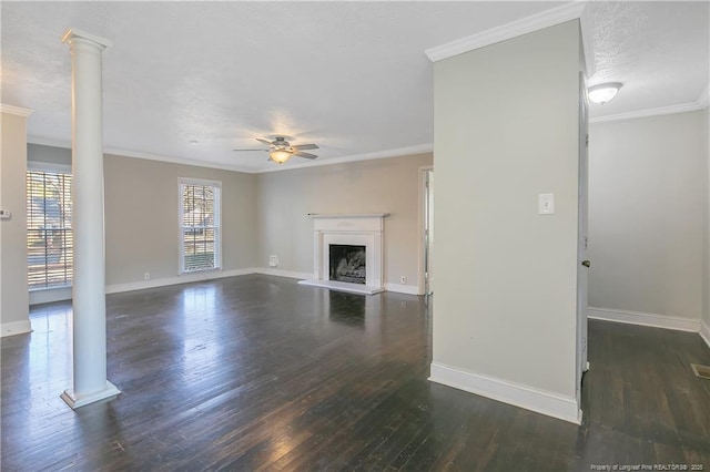 unfurnished living room with ceiling fan, ornamental molding, a textured ceiling, ornate columns, and dark hardwood / wood-style flooring