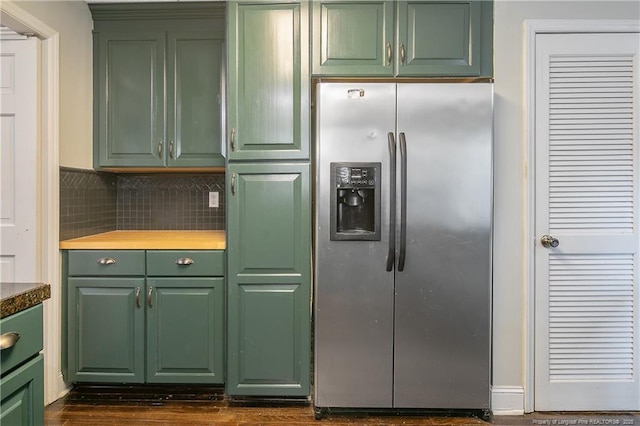 kitchen with stainless steel fridge with ice dispenser and tasteful backsplash