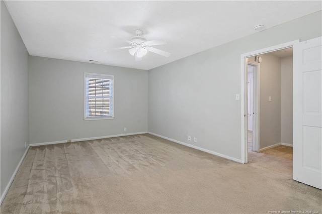 carpeted spare room with ceiling fan