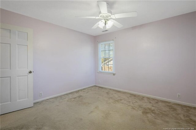 carpeted empty room with ceiling fan