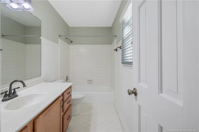 full bathroom featuring vanity, toilet, and tiled shower / bath combo