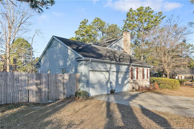 view of side of home featuring a garage