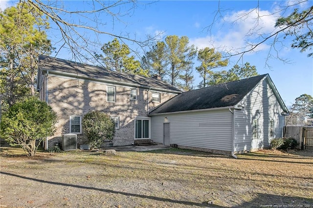 rear view of house featuring a yard