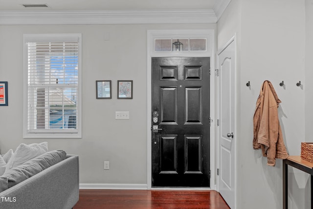 foyer entrance featuring dark wood-type flooring and ornamental molding