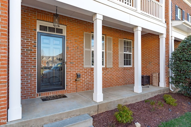 view of exterior entry with a porch