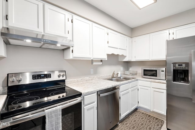 kitchen featuring white cabinets, appliances with stainless steel finishes, and sink