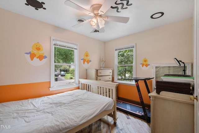 bedroom featuring ceiling fan and hardwood / wood-style flooring