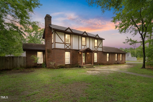 tudor home with a lawn