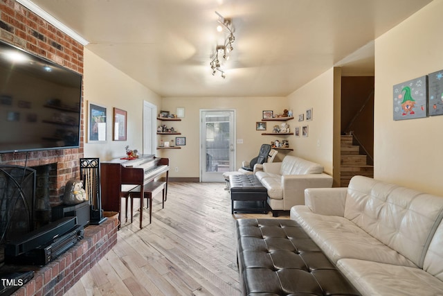 living room with a fireplace and light hardwood / wood-style floors