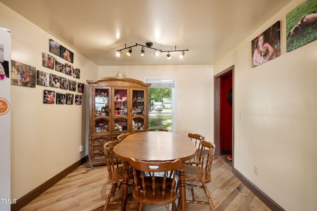 dining space featuring light wood-type flooring