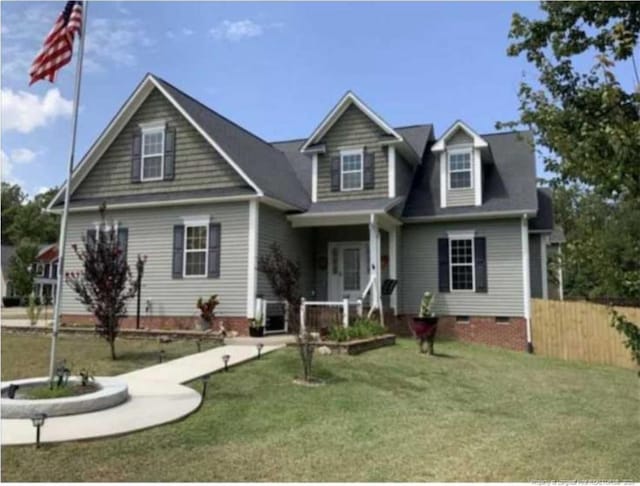 view of front of property with cooling unit and a front lawn