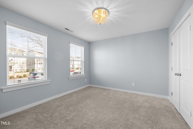 unfurnished bedroom with carpet flooring and a closet