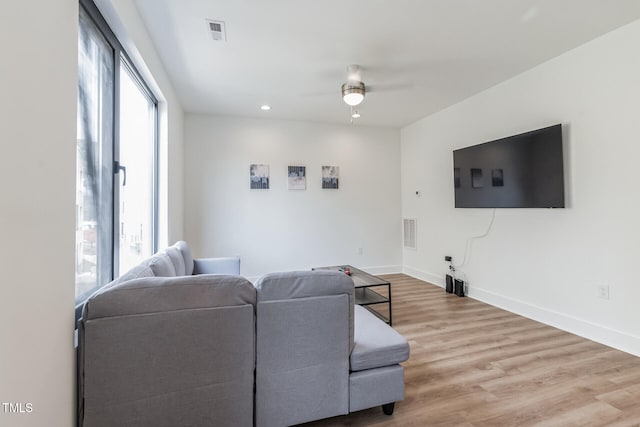 living room featuring ceiling fan and light wood-type flooring