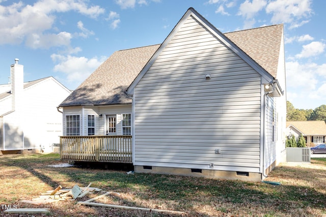 view of side of home featuring a yard and a deck