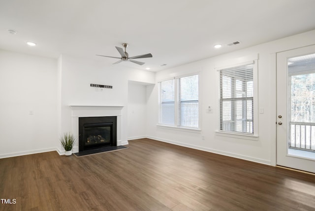 unfurnished living room with ceiling fan and dark hardwood / wood-style floors