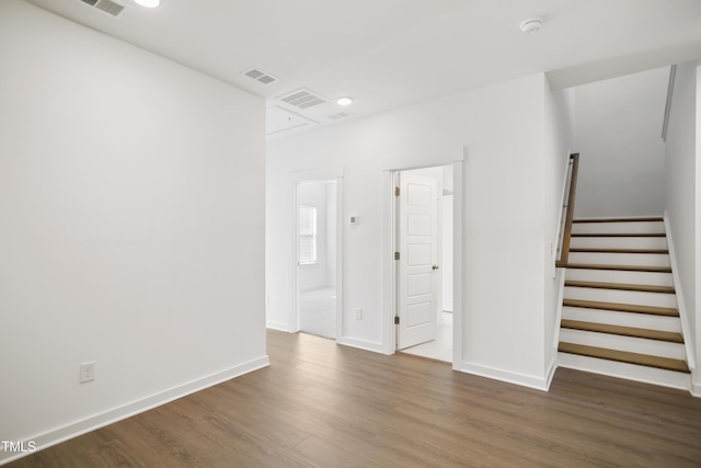 spare room with dark wood-type flooring