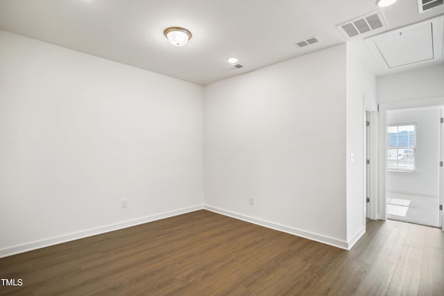 empty room with dark hardwood / wood-style flooring