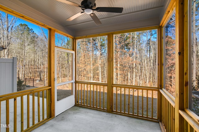 unfurnished sunroom featuring ceiling fan