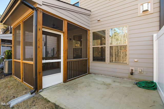 doorway to property with a patio area and central air condition unit