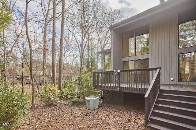 view of yard with a deck and central air condition unit