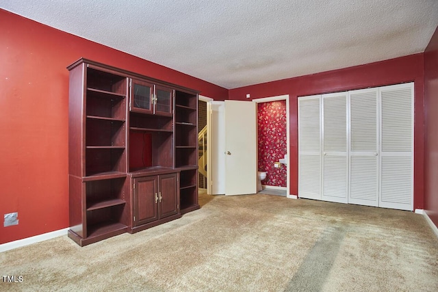 unfurnished bedroom featuring carpet flooring and a textured ceiling