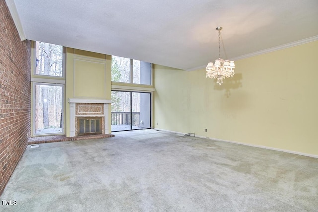 unfurnished living room featuring a towering ceiling, carpet floors, a notable chandelier, and brick wall