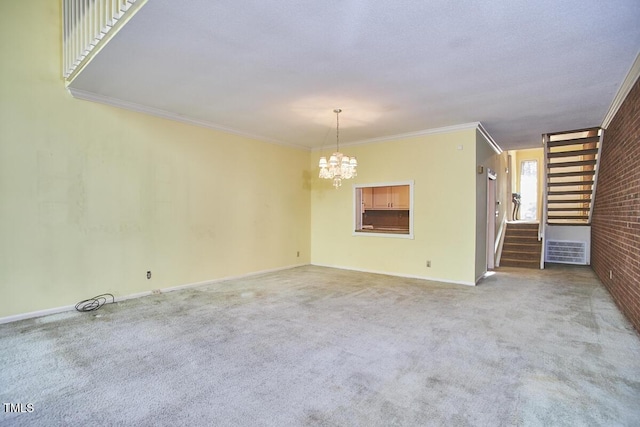 carpeted empty room with crown molding, brick wall, and an inviting chandelier