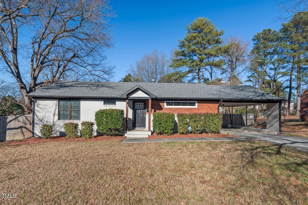 single story home with a front yard and a carport