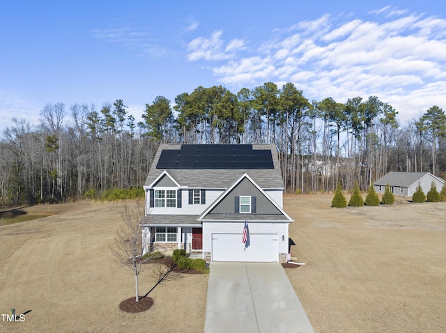 view of front of home featuring solar panels and a garage