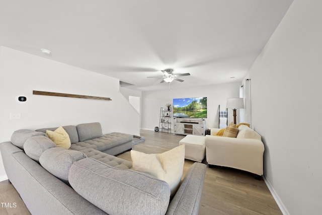 living room featuring ceiling fan and wood-type flooring