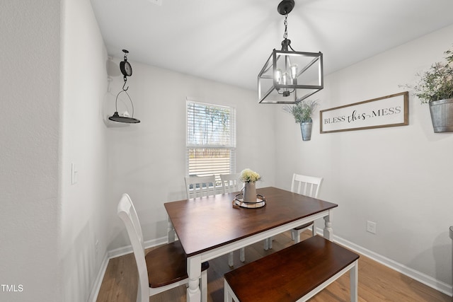 dining room with an inviting chandelier and hardwood / wood-style floors