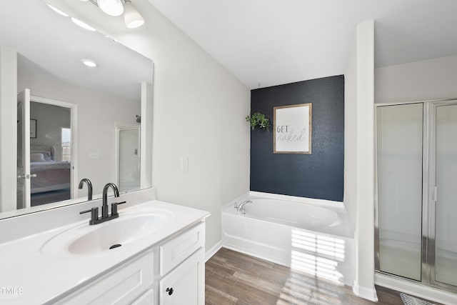 bathroom with separate shower and tub, wood-type flooring, and vanity