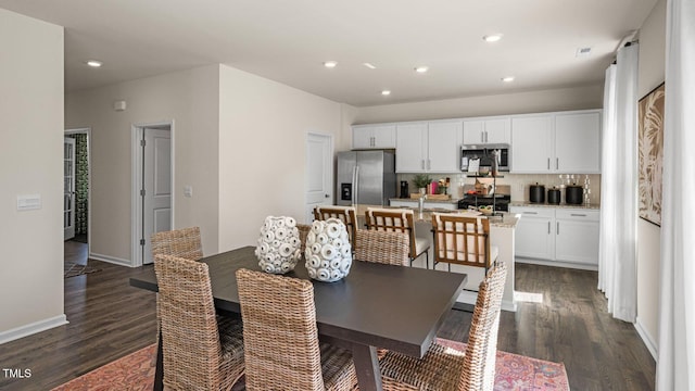 dining space featuring dark hardwood / wood-style floors