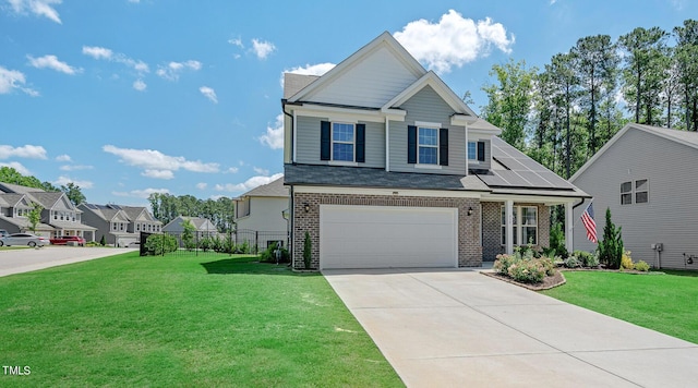 view of front of home featuring a front yard, solar panels, and a garage