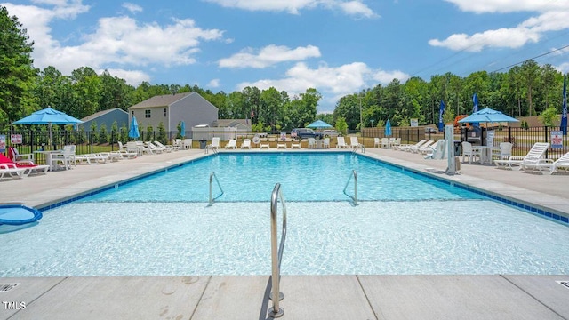 community pool featuring fence and a patio