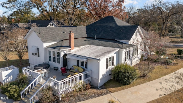 back of house featuring a wooden deck