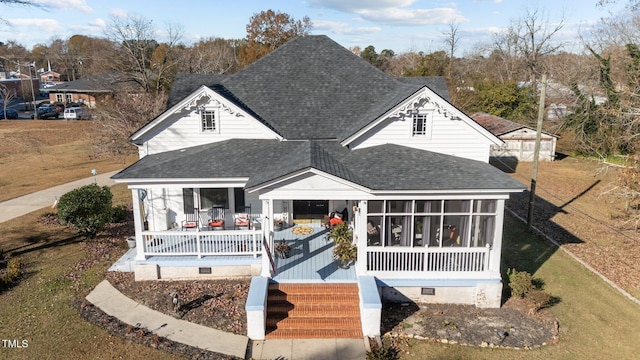 back of house with a porch and a sunroom