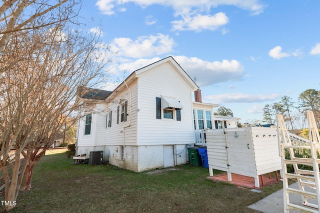 view of property exterior featuring a yard and central AC