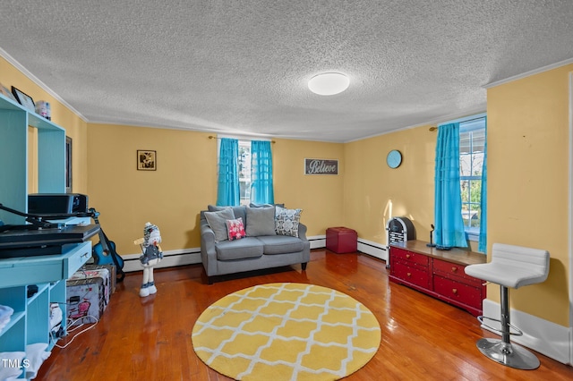 living room with a textured ceiling, hardwood / wood-style flooring, and baseboard heating