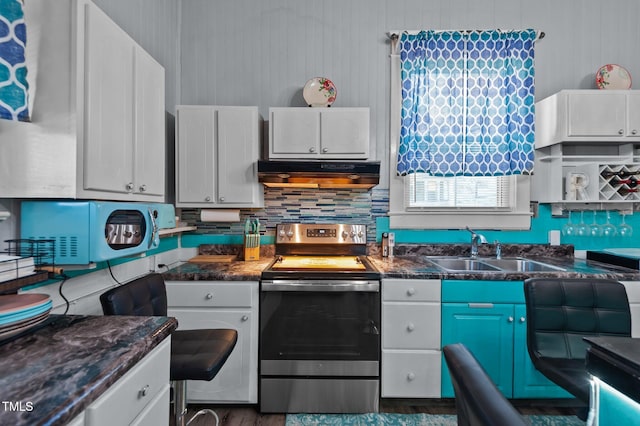 kitchen with electric stove, white cabinetry, sink, and ventilation hood