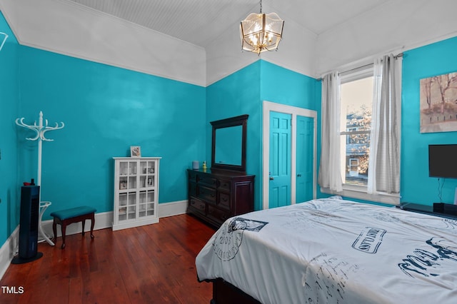 bedroom featuring a chandelier and dark hardwood / wood-style floors