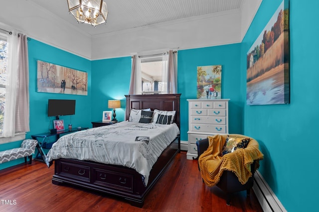 bedroom featuring multiple windows, dark wood-type flooring, a baseboard radiator, and ornamental molding